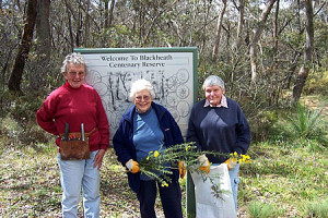 Founding members standing in front of Reserve sign